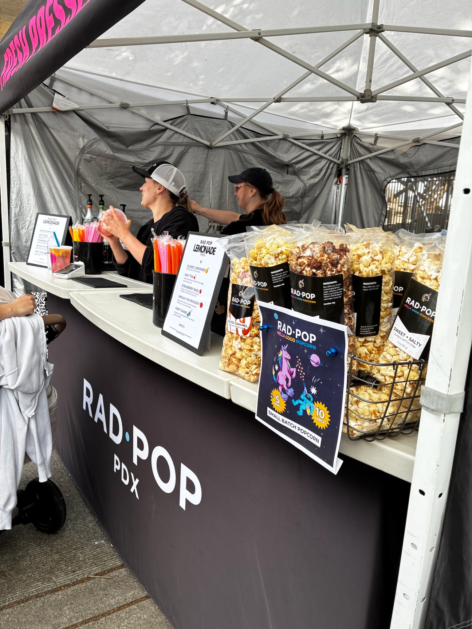Rad Pop market booth with popcorn bags and lemonade setup
