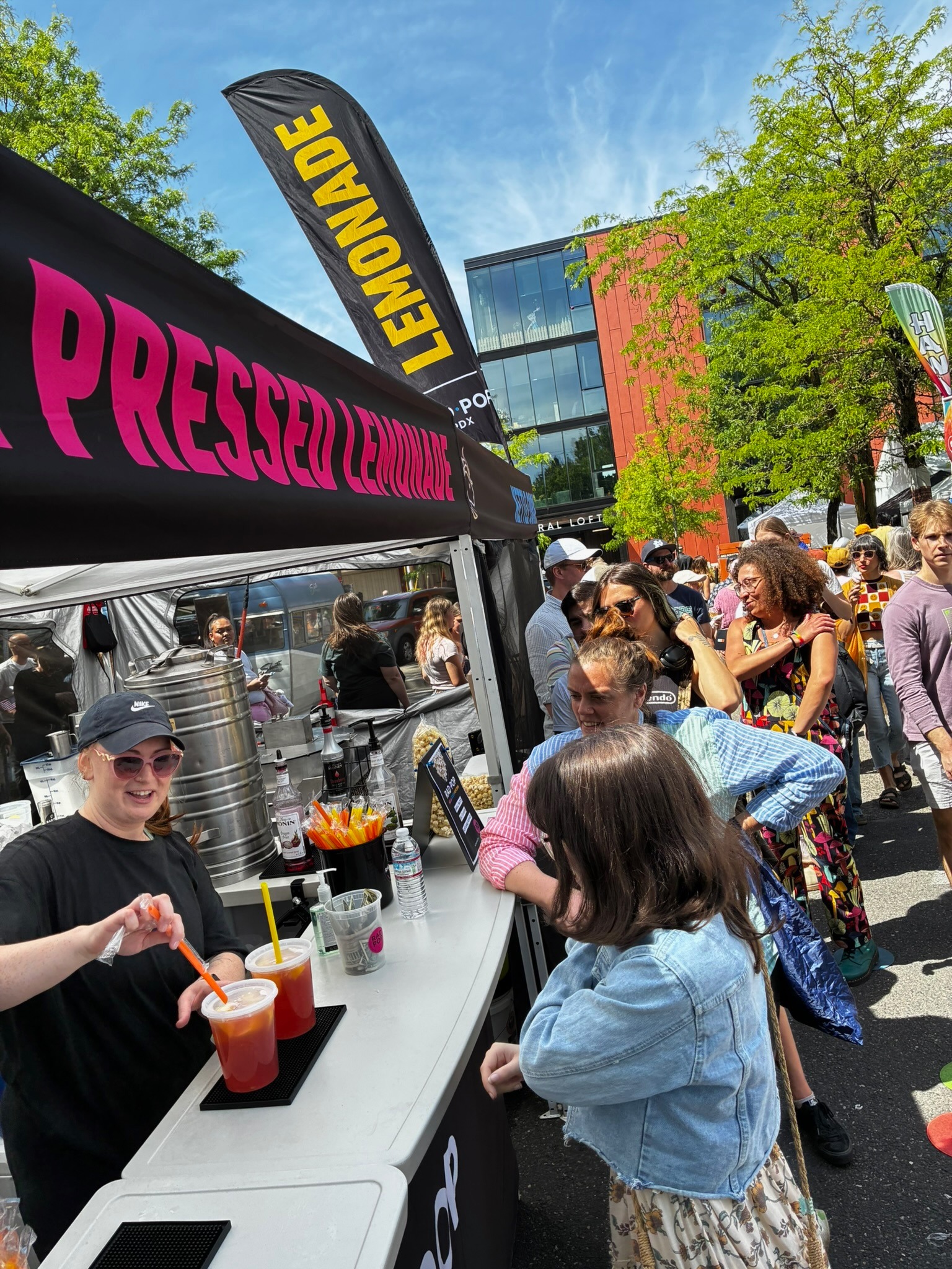 Crowd lined up outside the Rad Pop booth for fresh-pressed lemonade at a Portland street fair