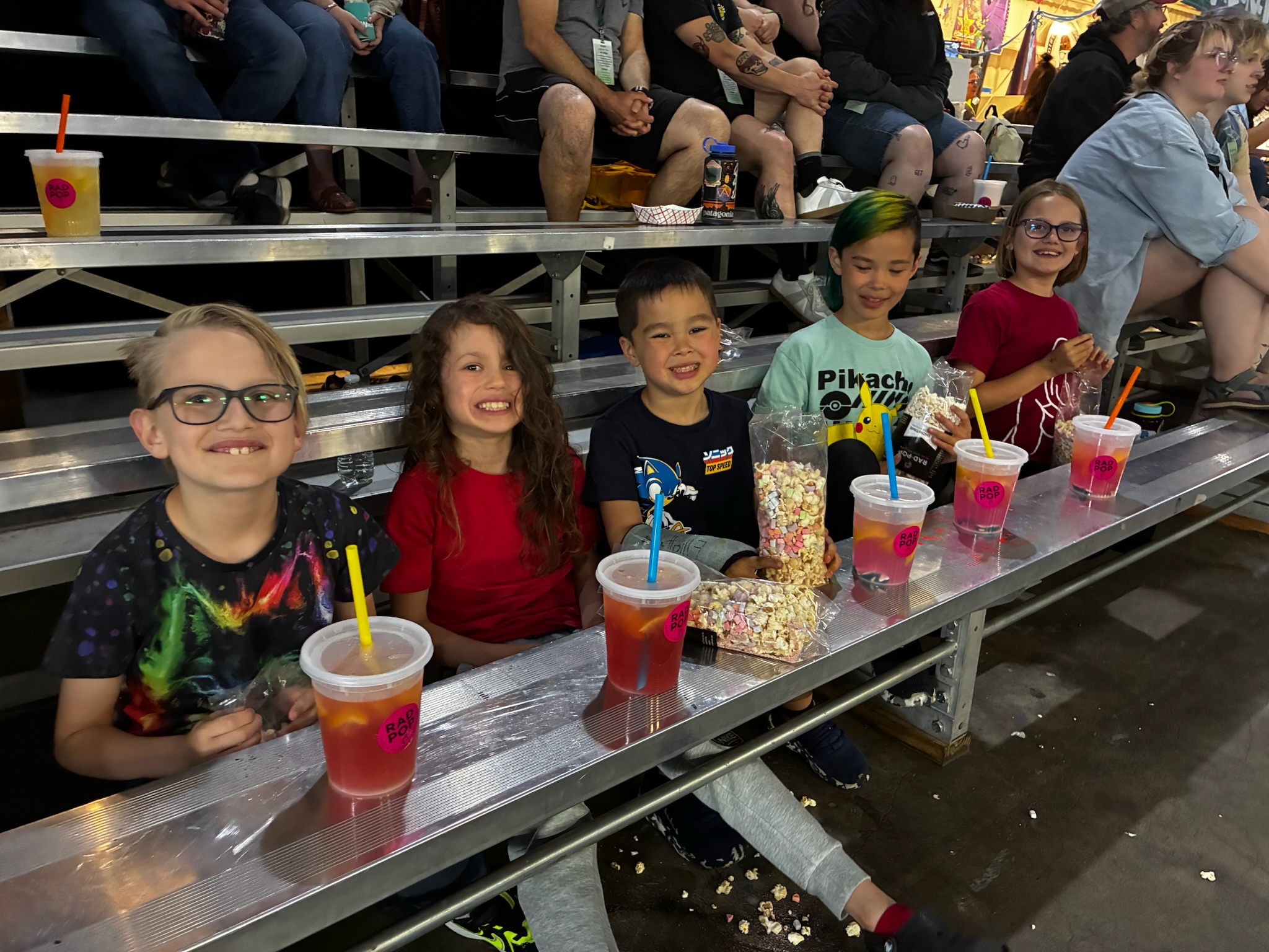 Kids at a roller derby event with Rad Pop drinks and popcorn